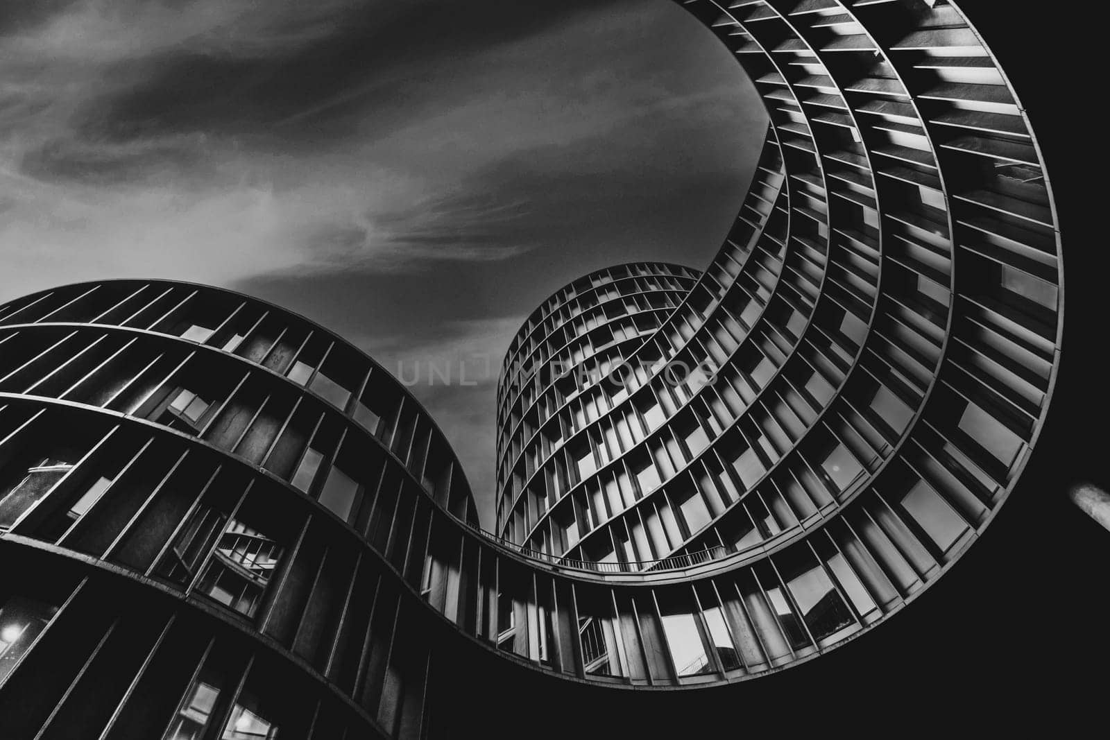 Low angle shot of Axel Towers Copenhagen on a cludy day in Copenhagen, Denmark. Axel Towers Copenhagen is an abstract contemporary architectural office building and consists of five cylindrical towers consisting of metal, copper and glass.
