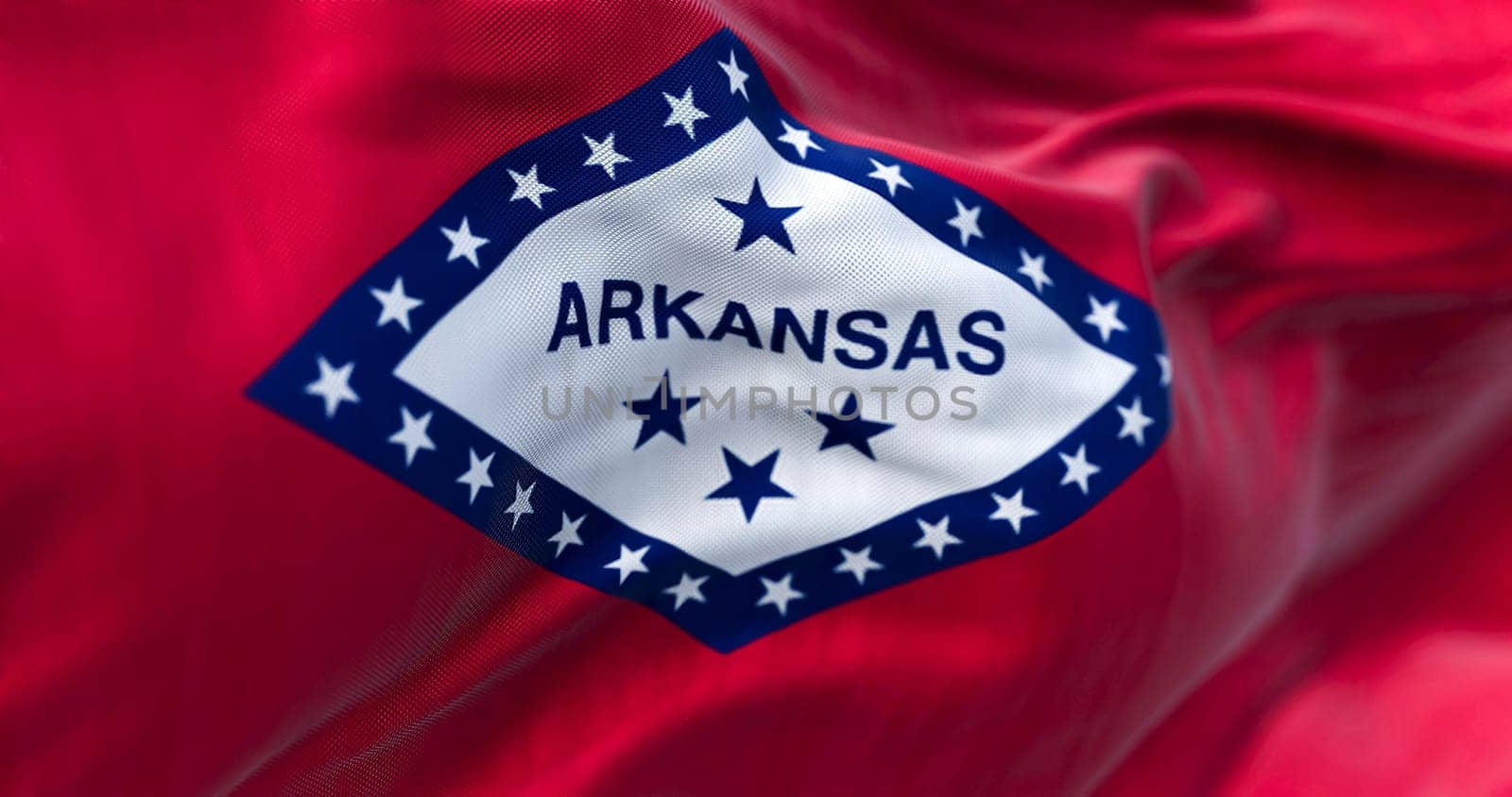 Close-up view of Arkansas state flag waving. Arkansas is a United States state. Fabric textured background. Selective focus