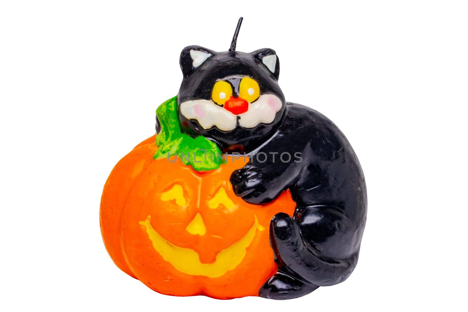 Halloween background. Close-up of a decorative Halloween candle consisting of a pumpkin with a black cat on it isolated on a white background. Clipping path. Macro.