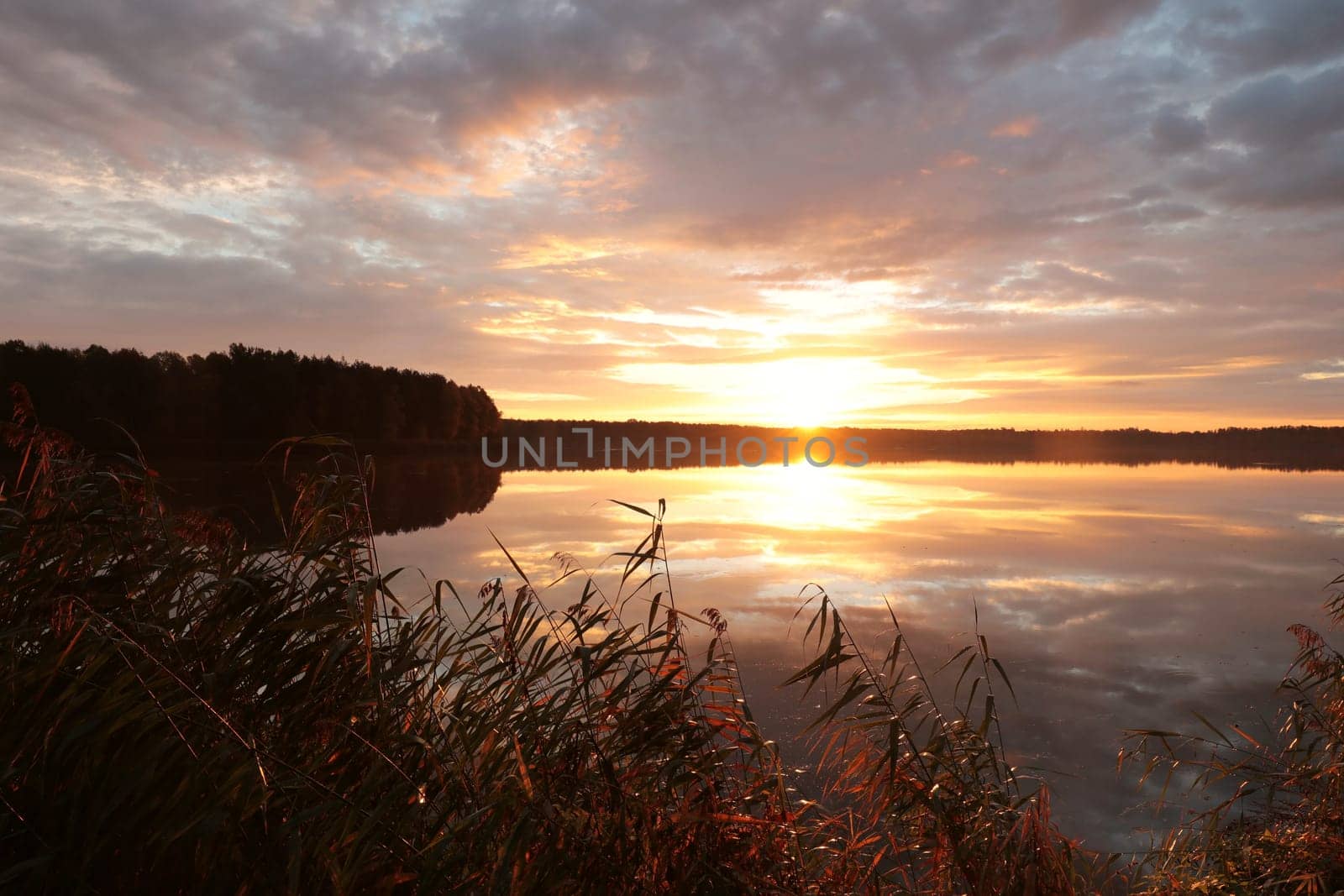 Sunrise over the lake on a cloudy autumn day