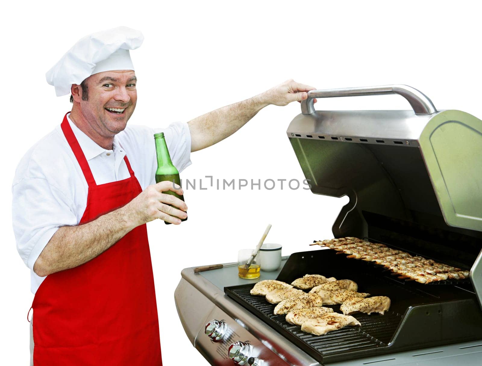 A happy smiling cook making dinner on his barbecue grill.  Isolated on white.