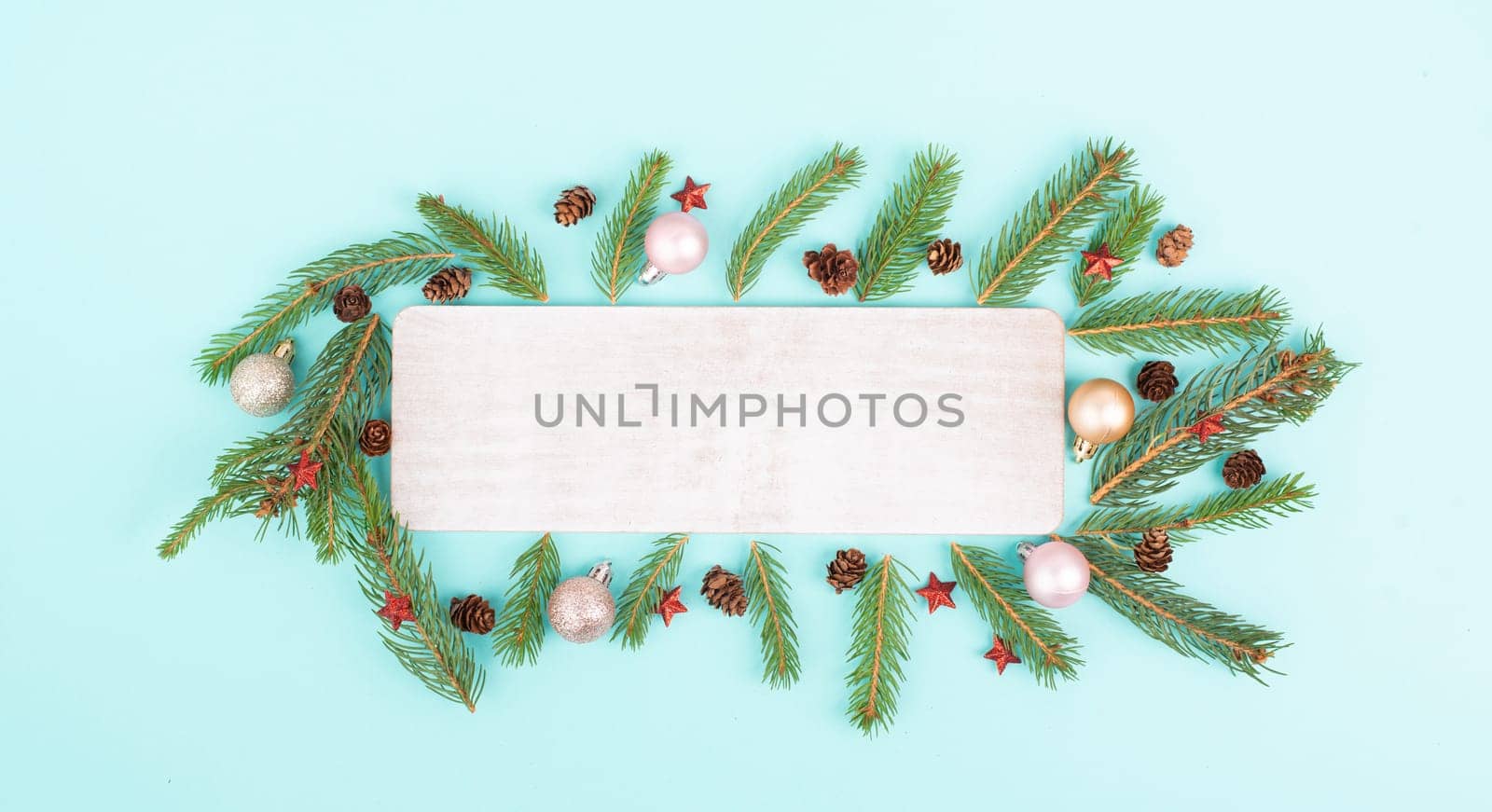 Christmas holiday background, frame with fir branches, baubles and cones, winter season greeting card