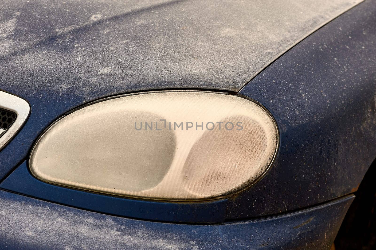 the front headlight of the car covered with frost. High quality photo