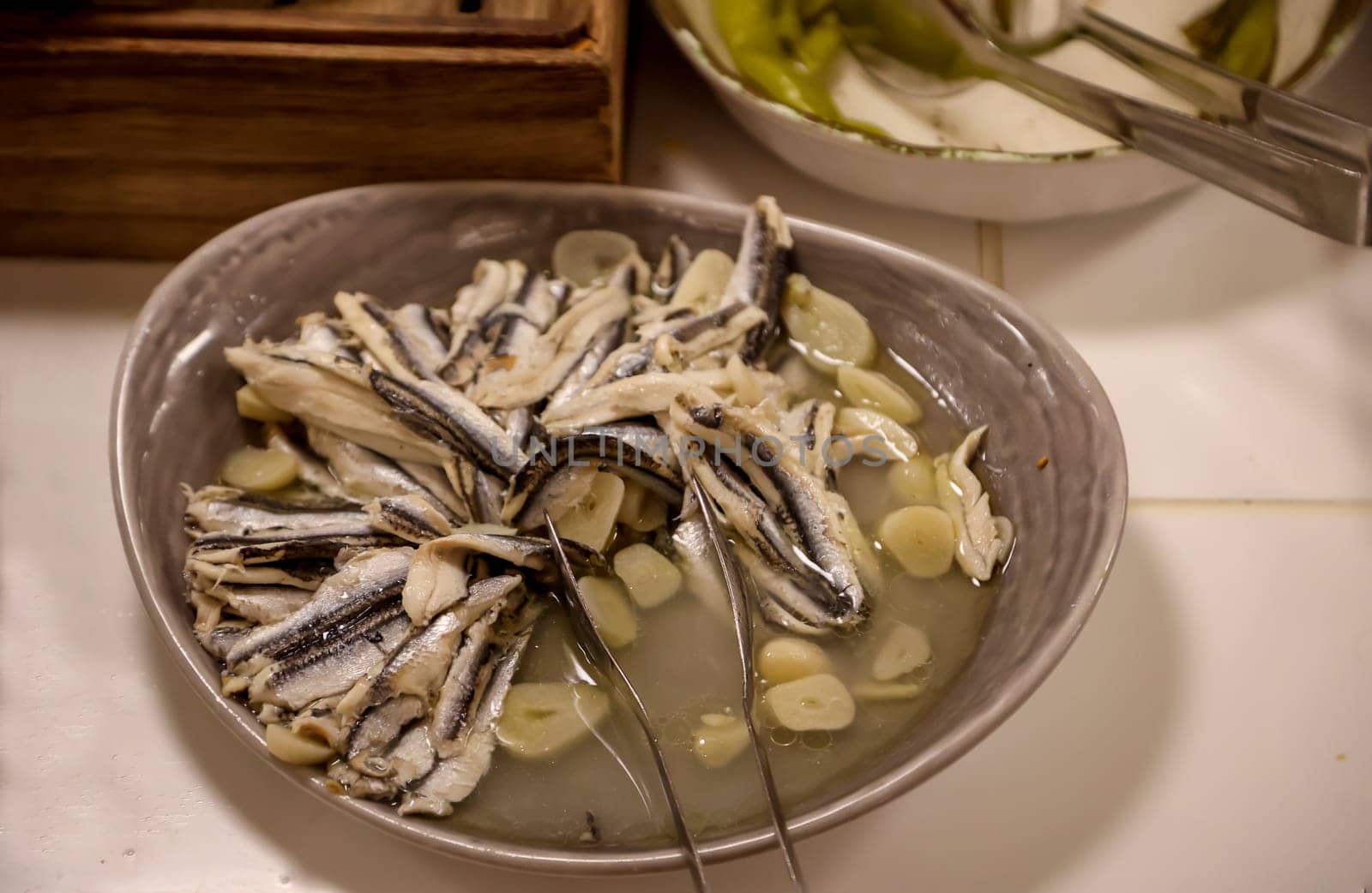 Small fish, similar to sprats in a bowl on a buffet.