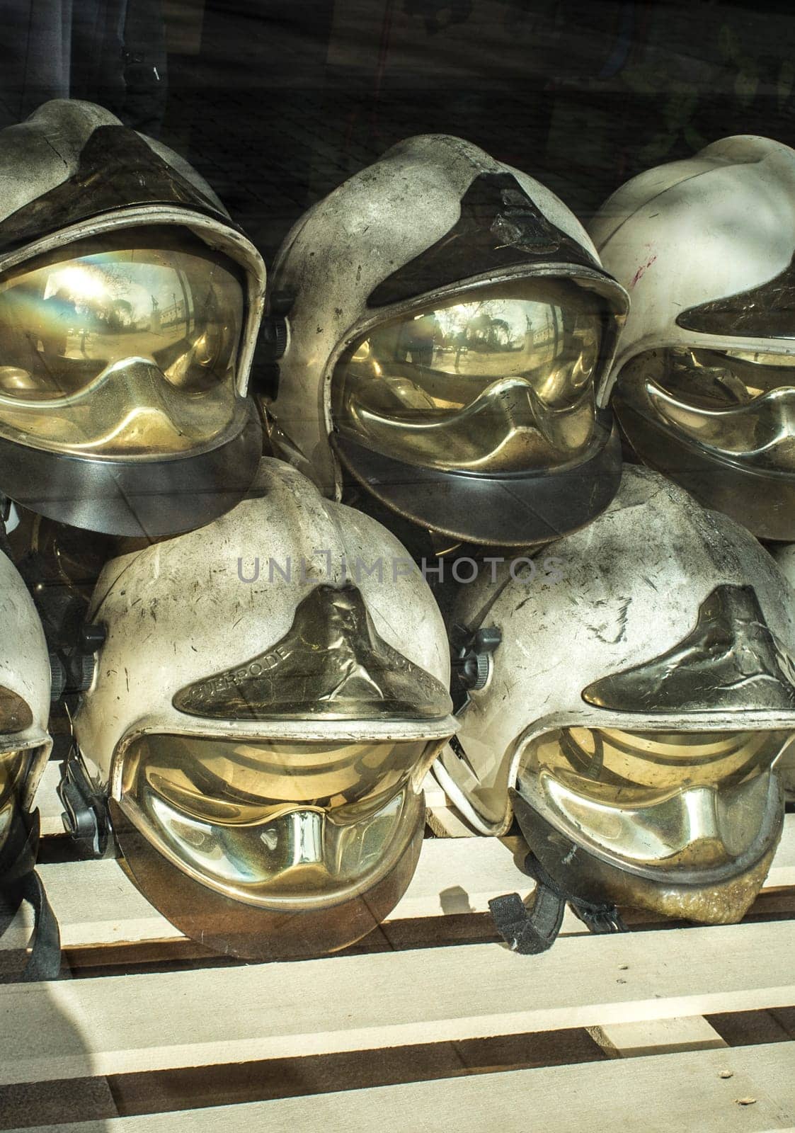 Pile of old firefighter helmets. Obsolete firefighter equipment