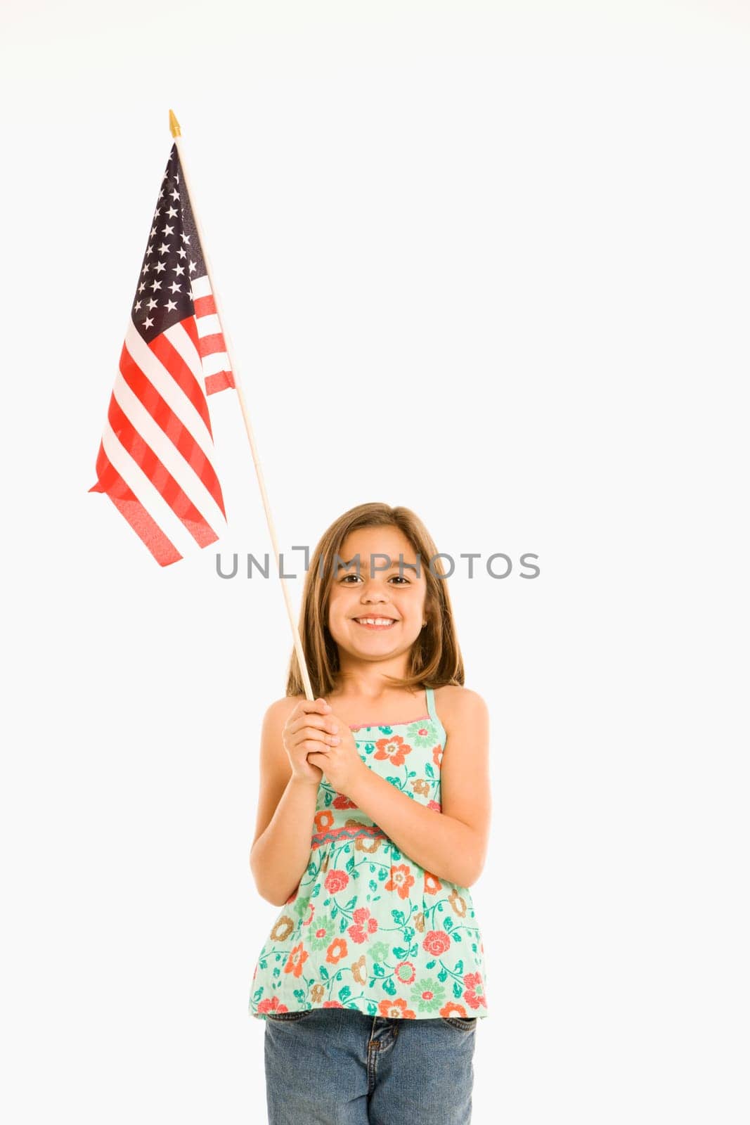 Girl holding American flag against white background.