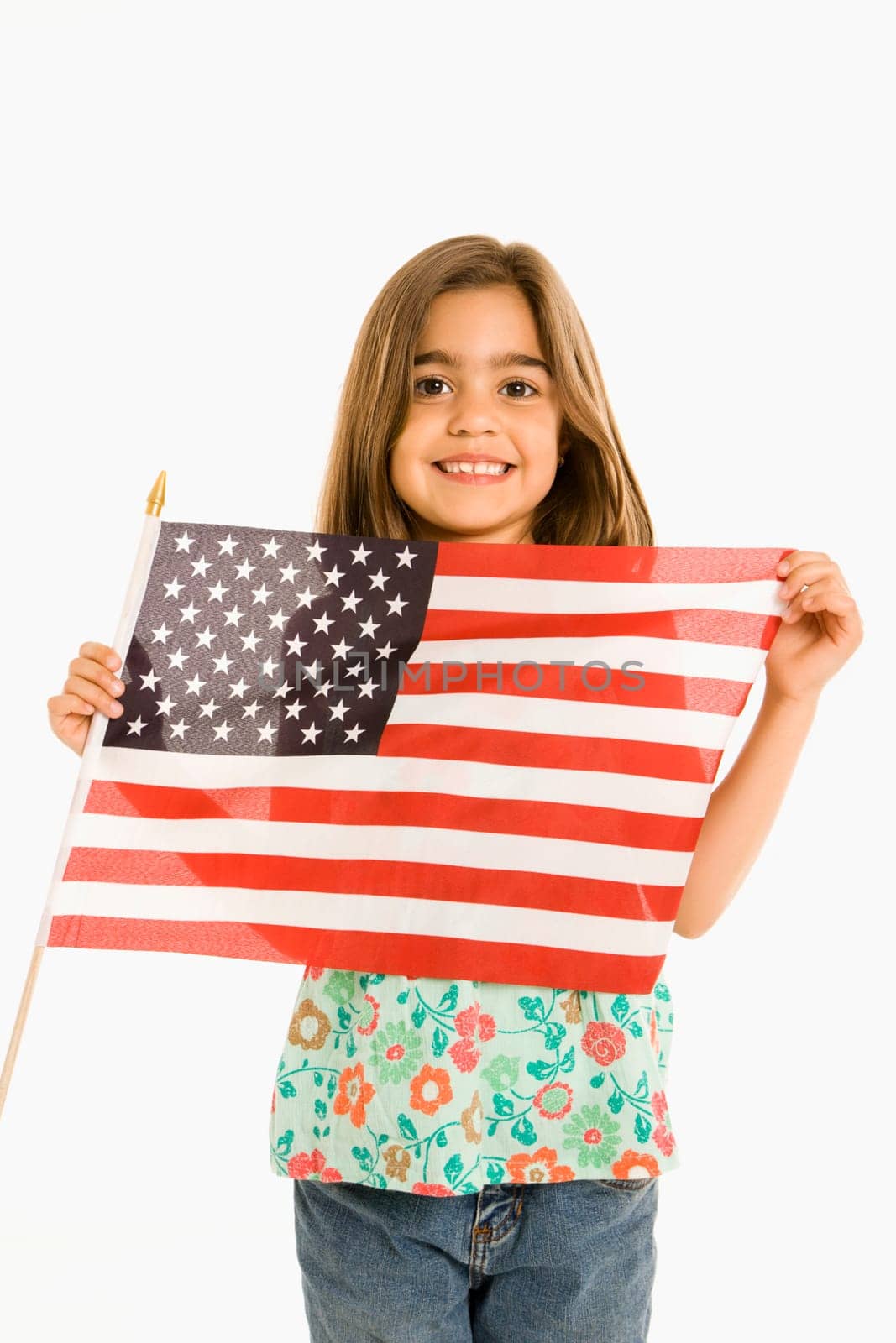 Girl holding American flag against white background.