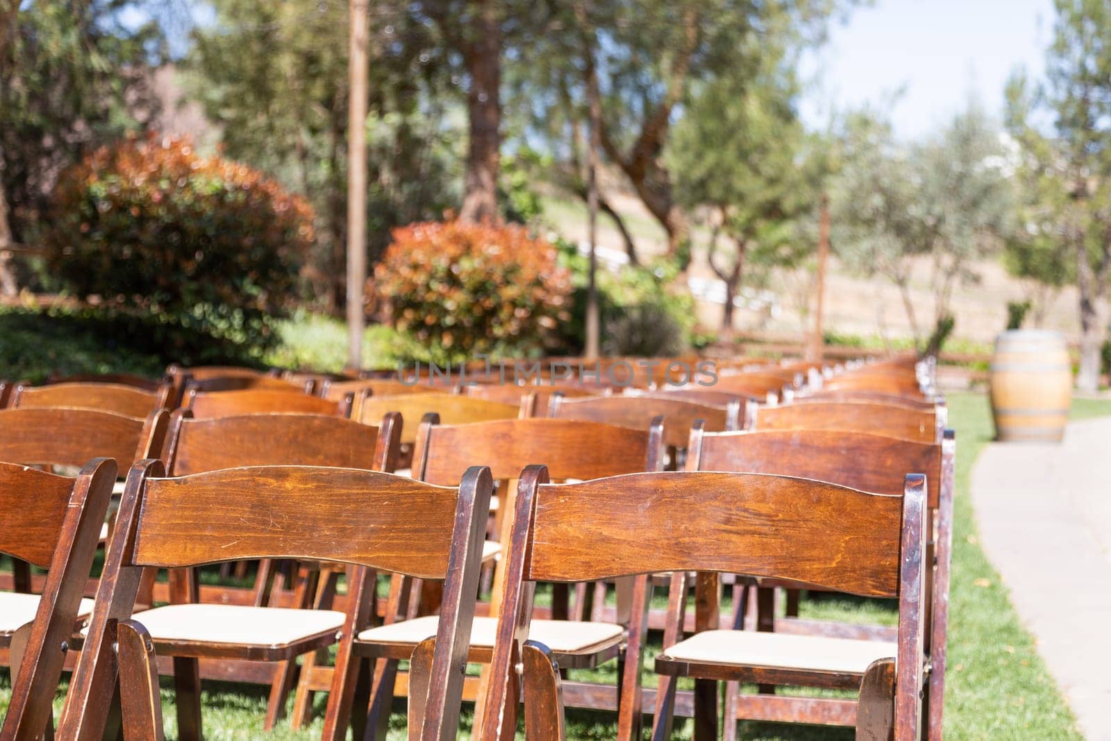 Rows of Wooden Event Chairs at Wedding Venue Abstract.