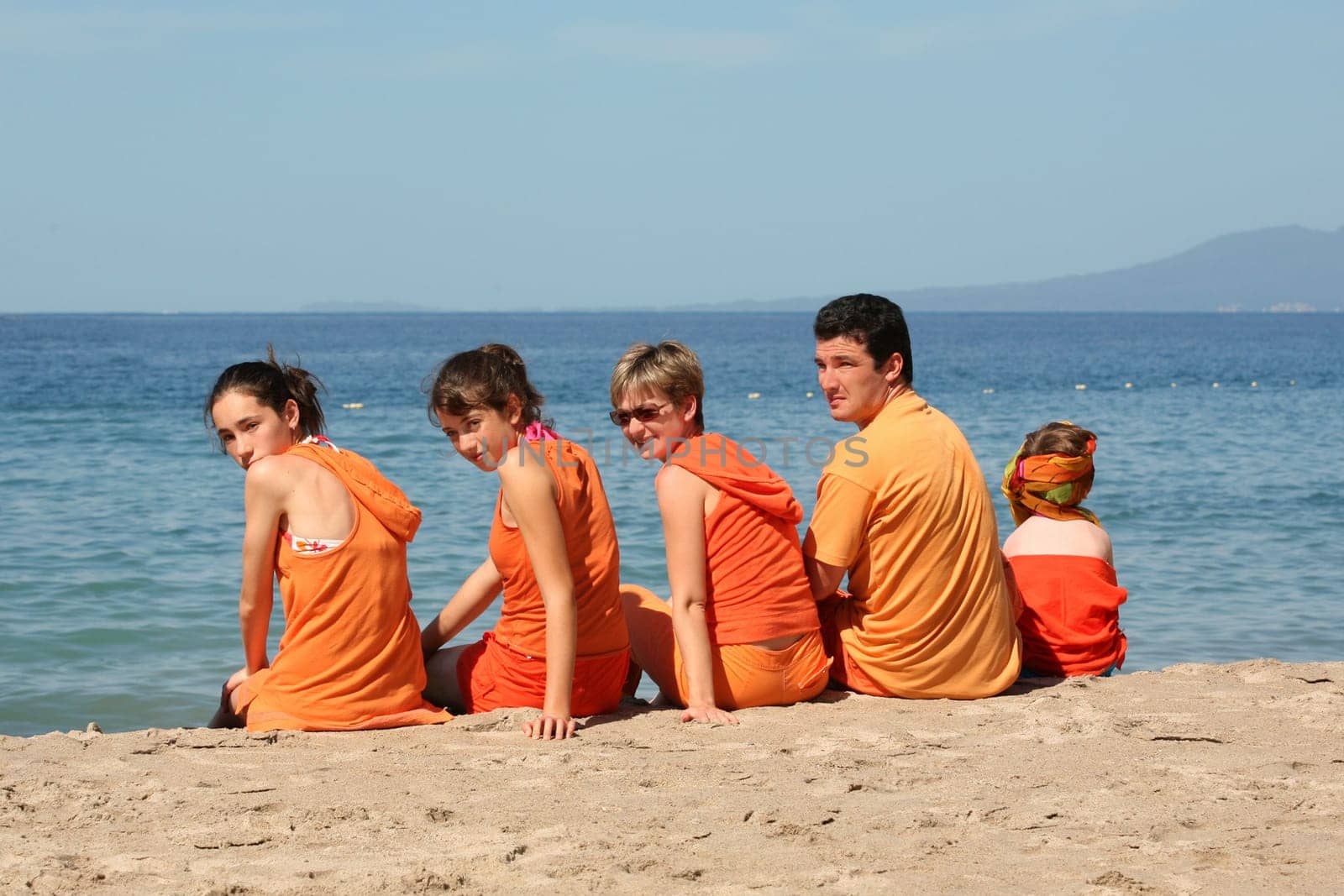 People in orange clothes on the beach