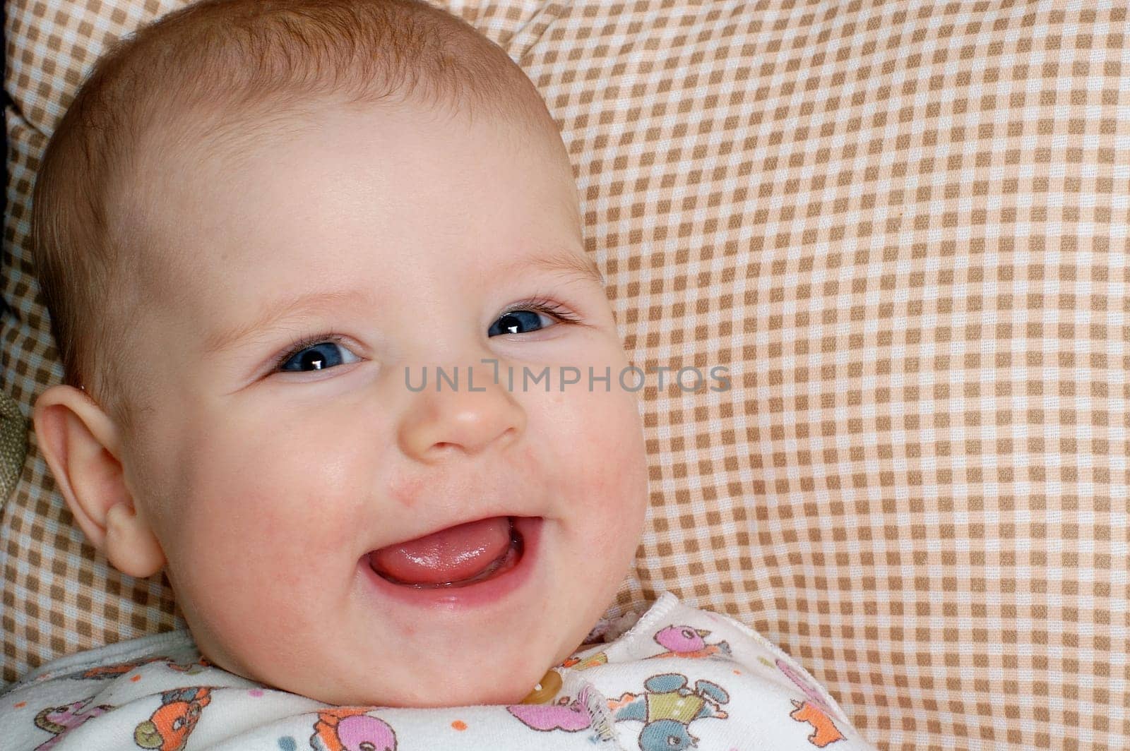 a very happy little baby, sincerely laughing