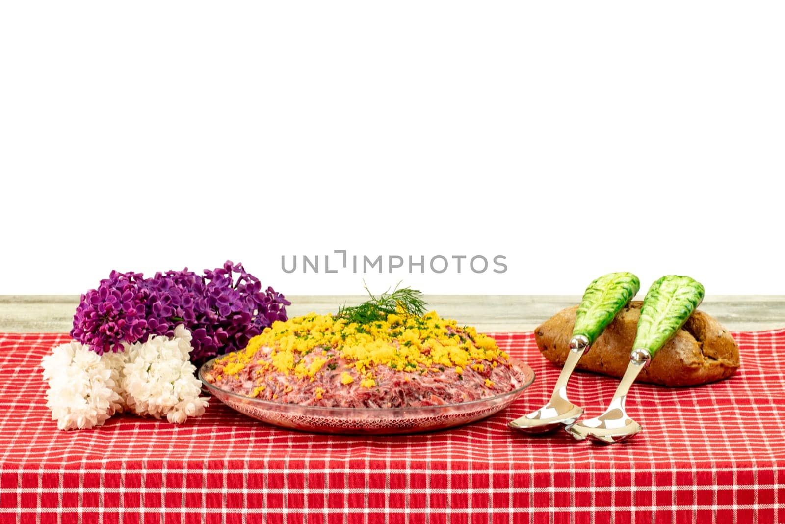Traditional russian layered salad named herring under a fur coat. Traditional Russian cusine on a rustic wooden table isolated on white background. Concept Russian food.