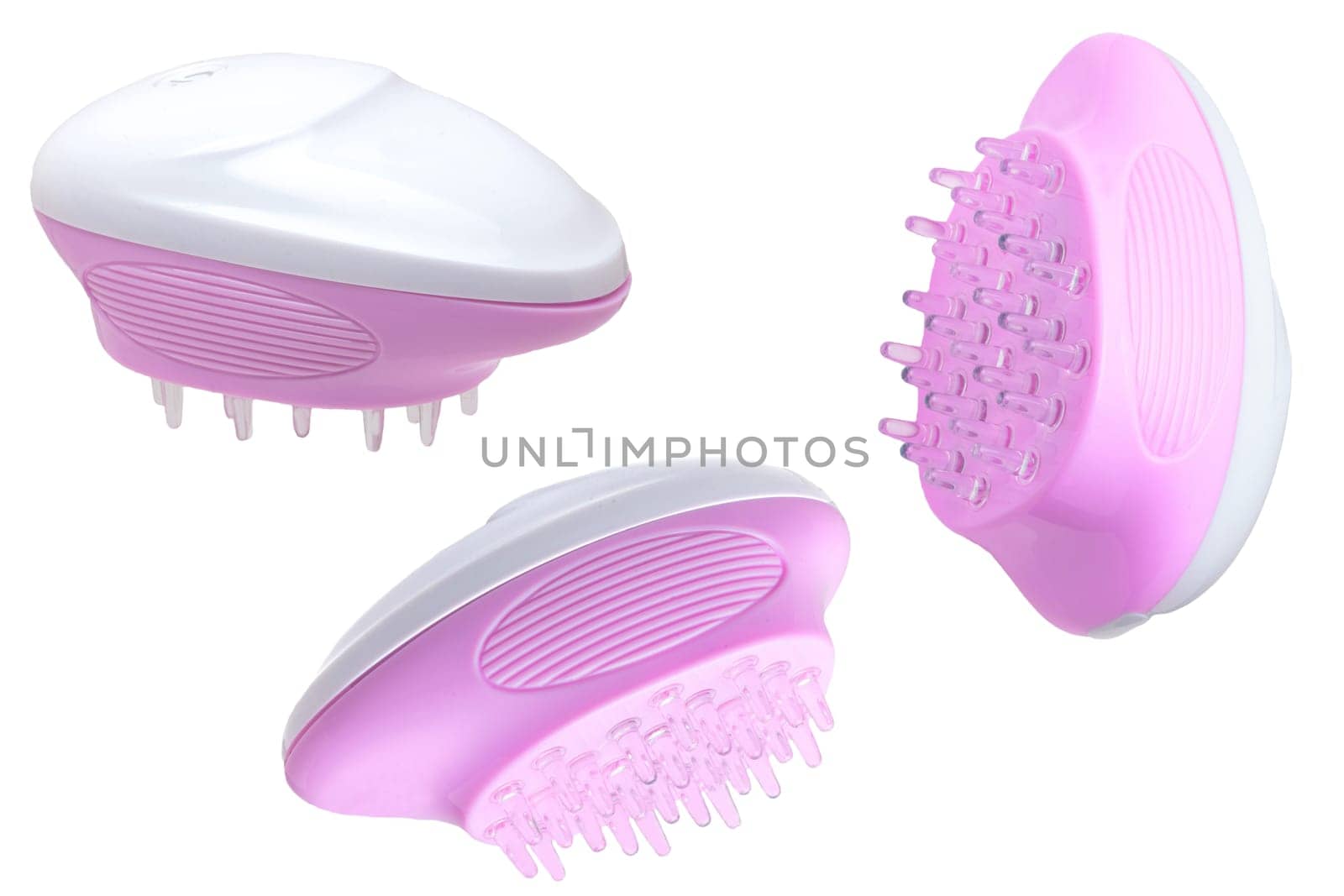 Close up of three battery operated scalp massage brushes, shampoo brushes or scalp massager for exfoliating and massaging the scalp. Beauty and health concept.