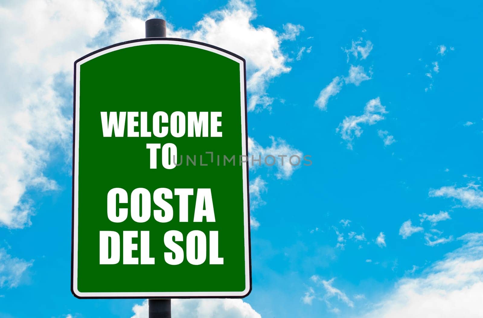 Green road sign with greeting message WELCOME TO COSTA DEL SOL isolated over clear blue sky background with available copy space. Travel destination concept  image