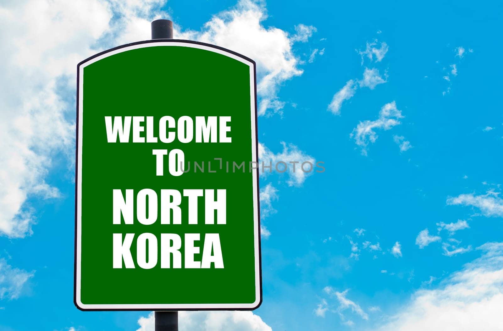 Green road sign with greeting message WELCOME TO NORTH KOREA isolated over clear blue sky background with available copy space. Travel destination concept  image