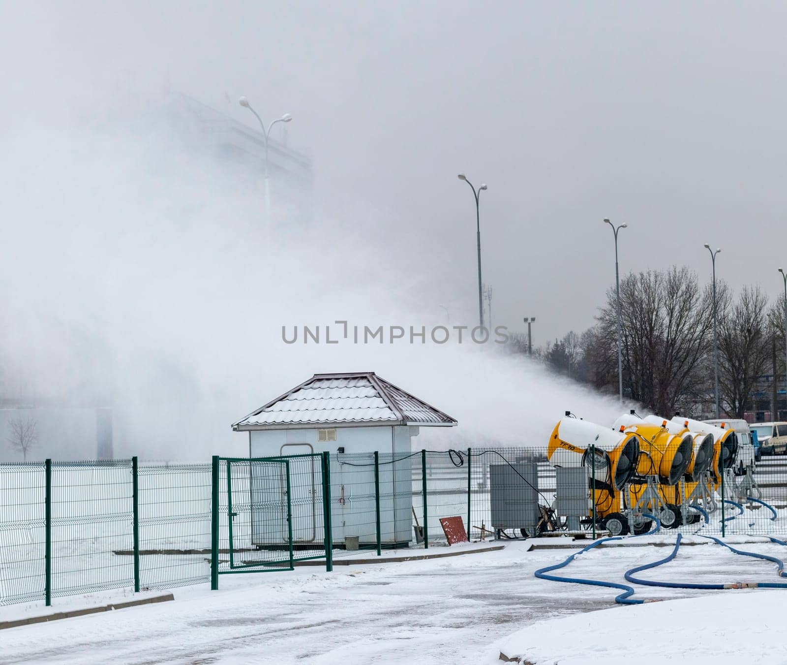 Shot of the industrial machinery so called snow gun or snow cannon that produces artificial snow in action.