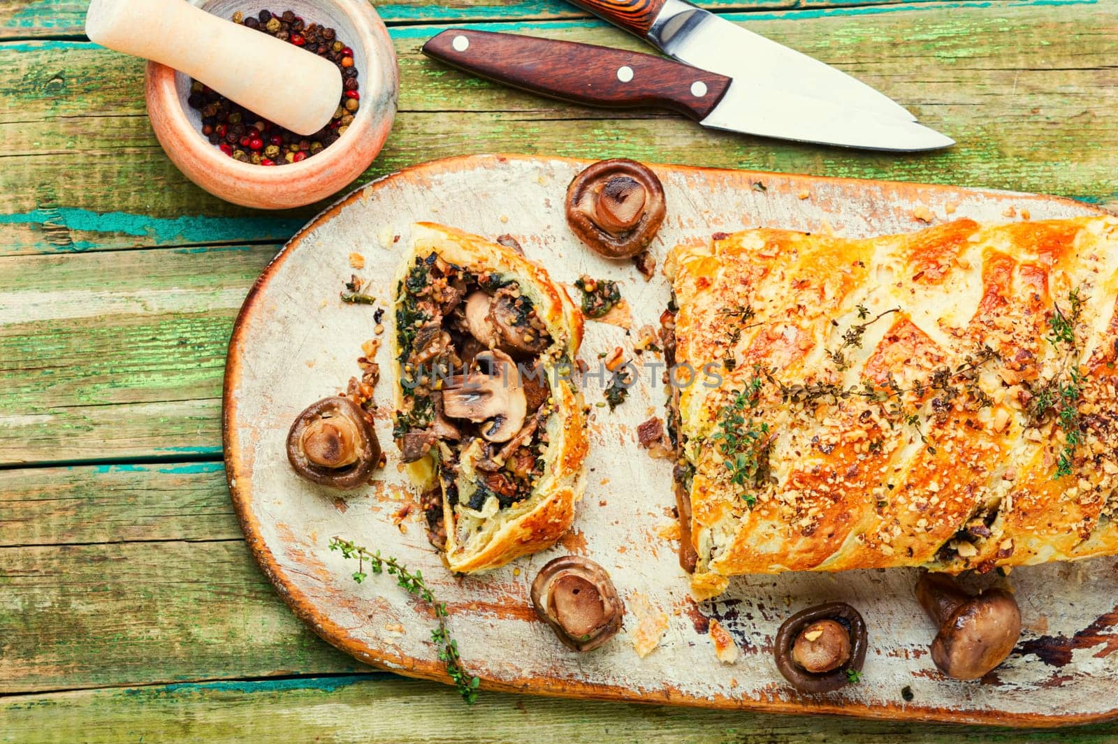 Piece closed homemade savory tart pie with mushrooms and persimmon