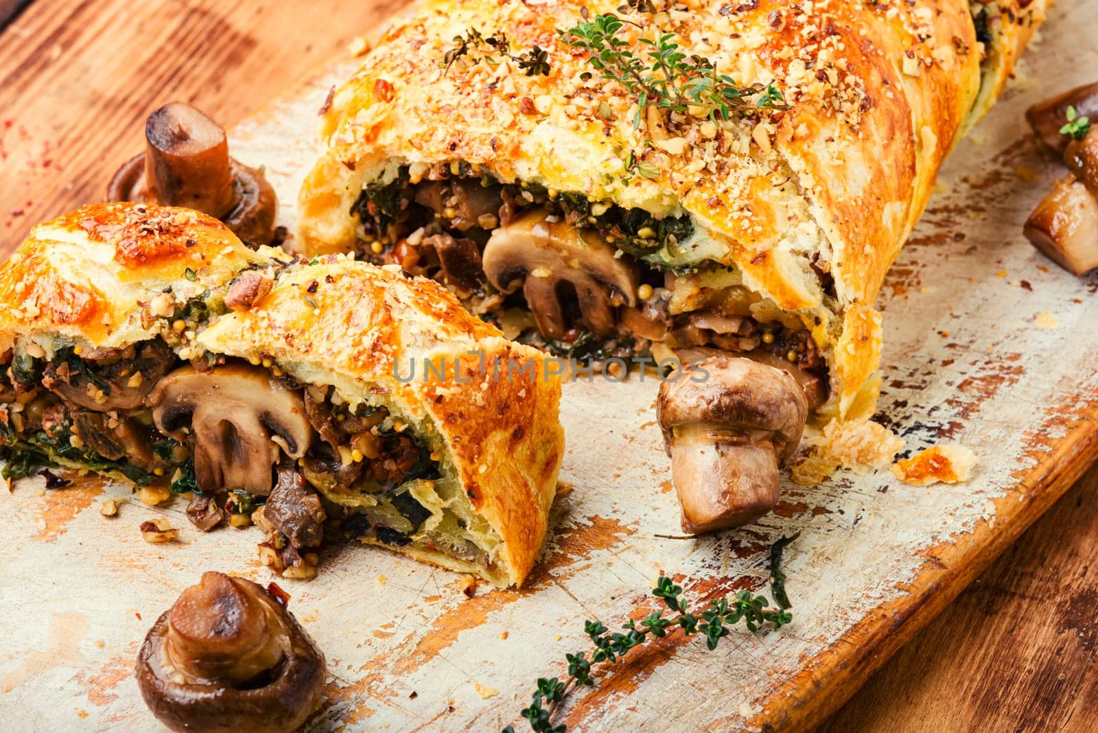 Piece closed homemade savory tart pie with mushrooms and persimmon