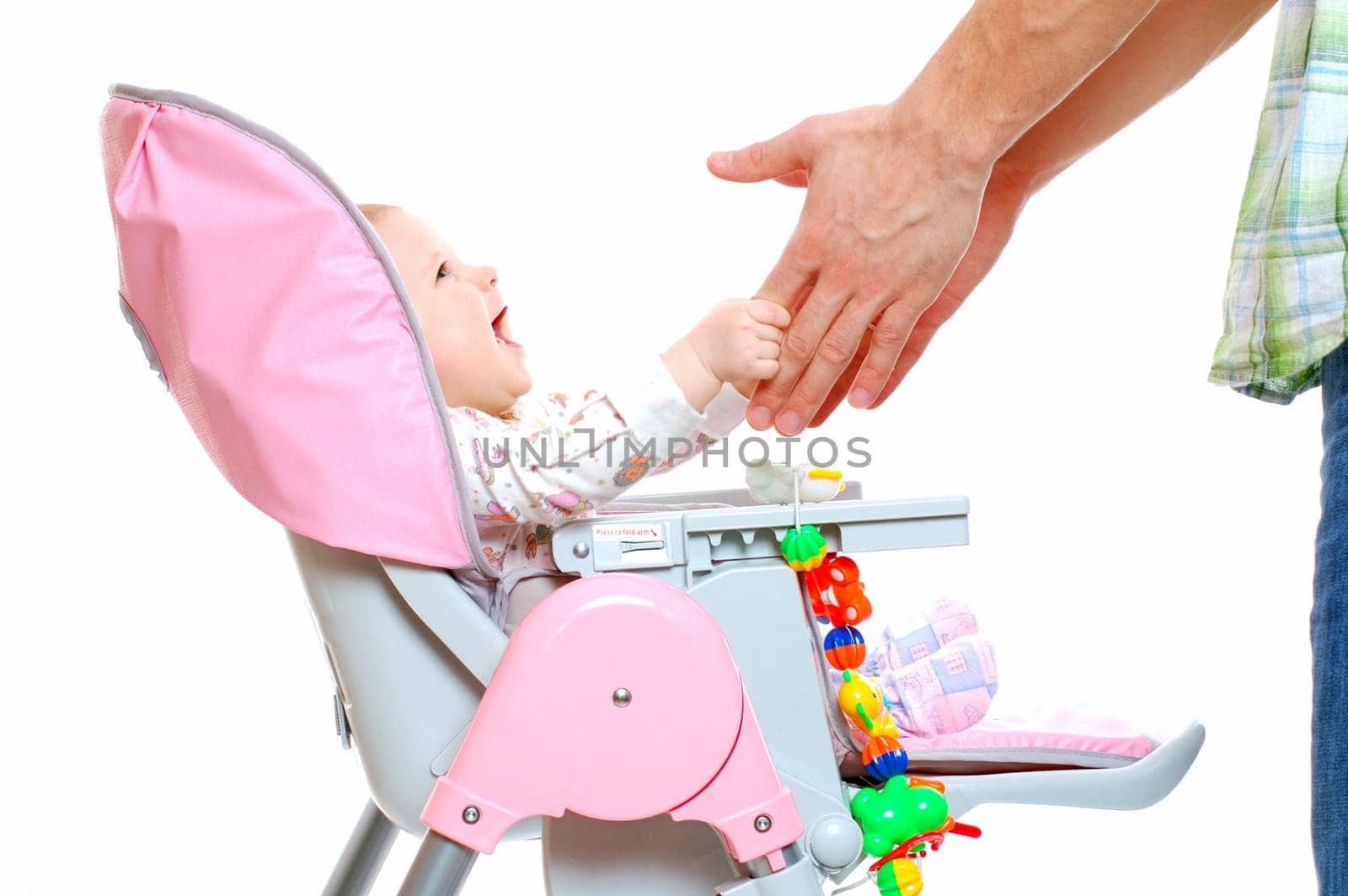 happy laughing baby touching her father hands