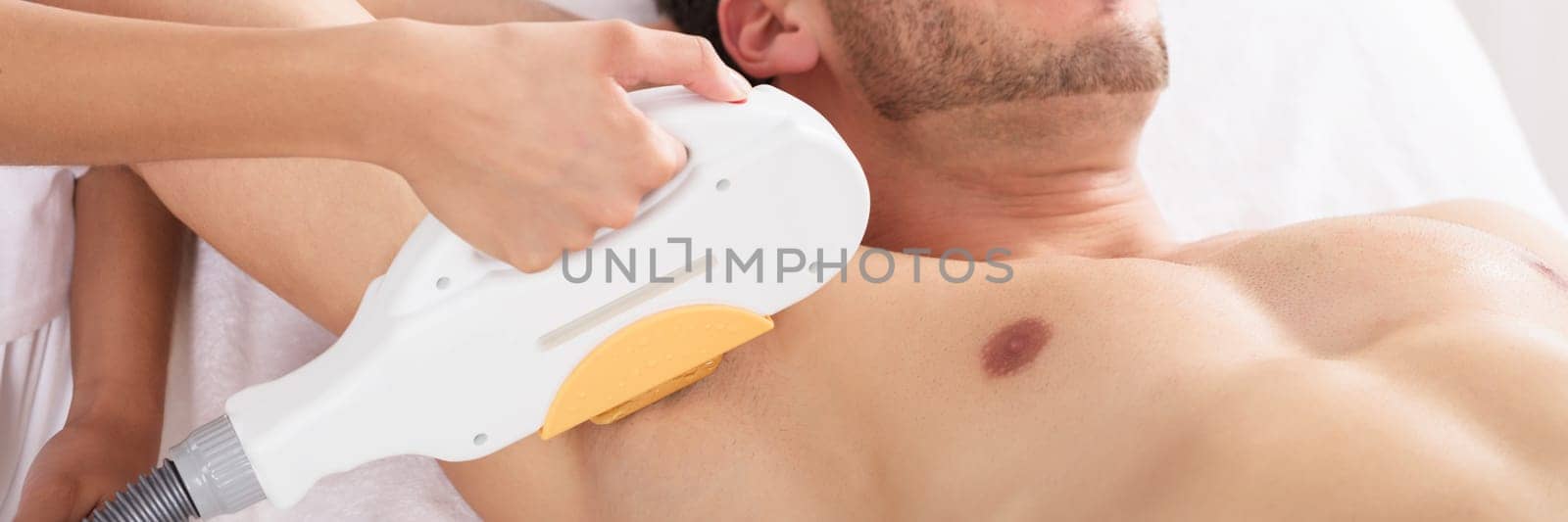 Young Woman Having Underarm Laser Hair Removal Treatment In Beauty Spa Clinic