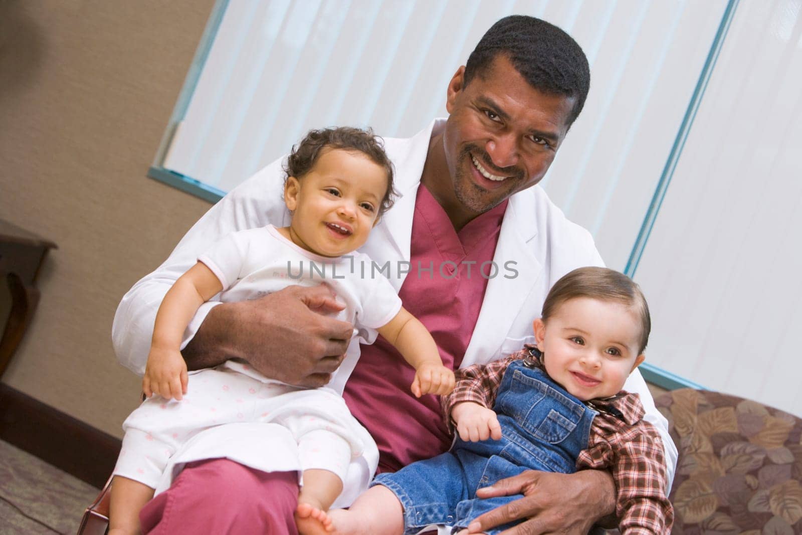 Consultant holding two IVF conceived children