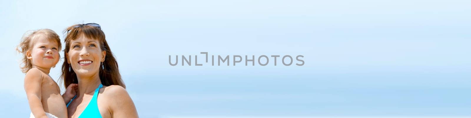 portrait of young happy mother holding her  baby . banner, lots of copy space