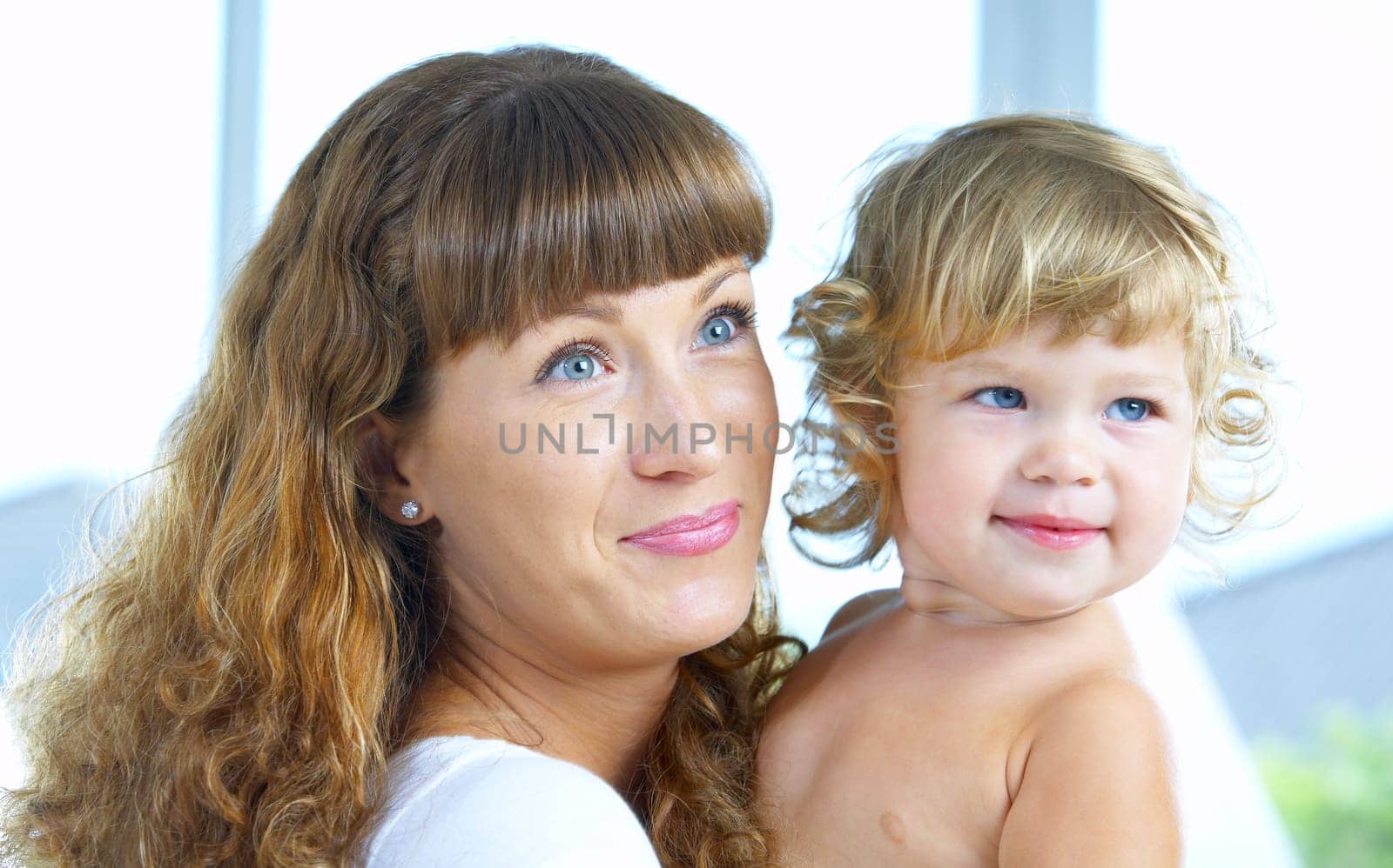 High key portrait of happy mother with baby