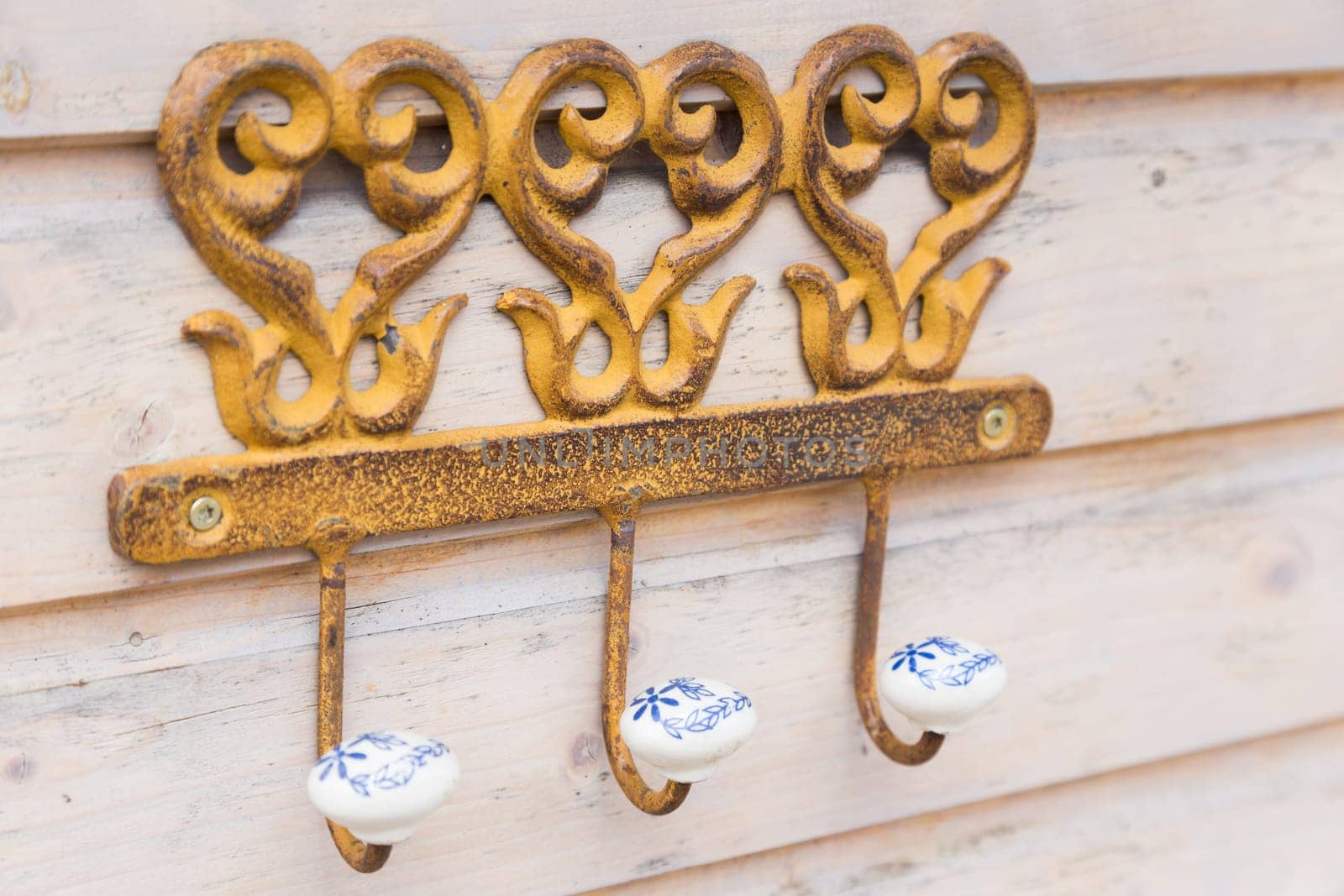 Coat hooks made of metal and ceramic on an outer wall