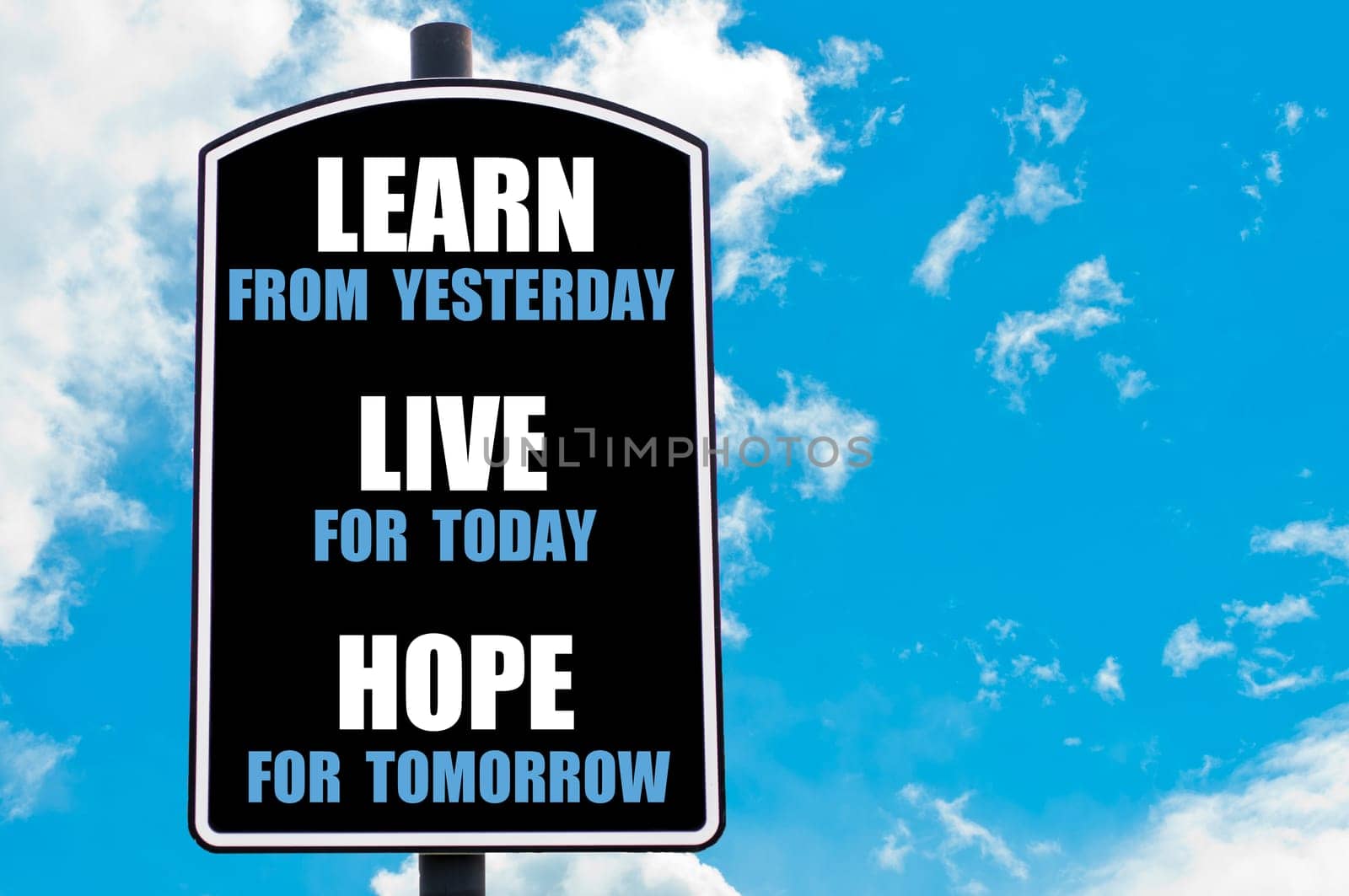 LEARN FROM YESTERDAY, LIVE FOR TODAY, HOPE FOR TOMORROW  motivational quote written on road sign isolated over clear blue sky background with available copy space. Concept  image