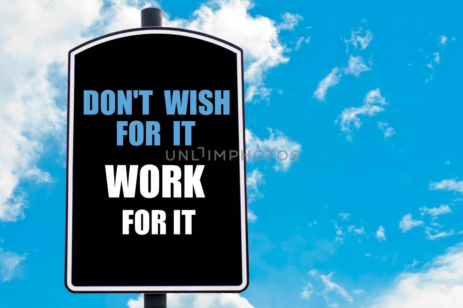 DO NOT WISH FOR IT WORK FOR IT  motivational quote written on road sign isolated over clear blue sky background with available copy space. Concept  image