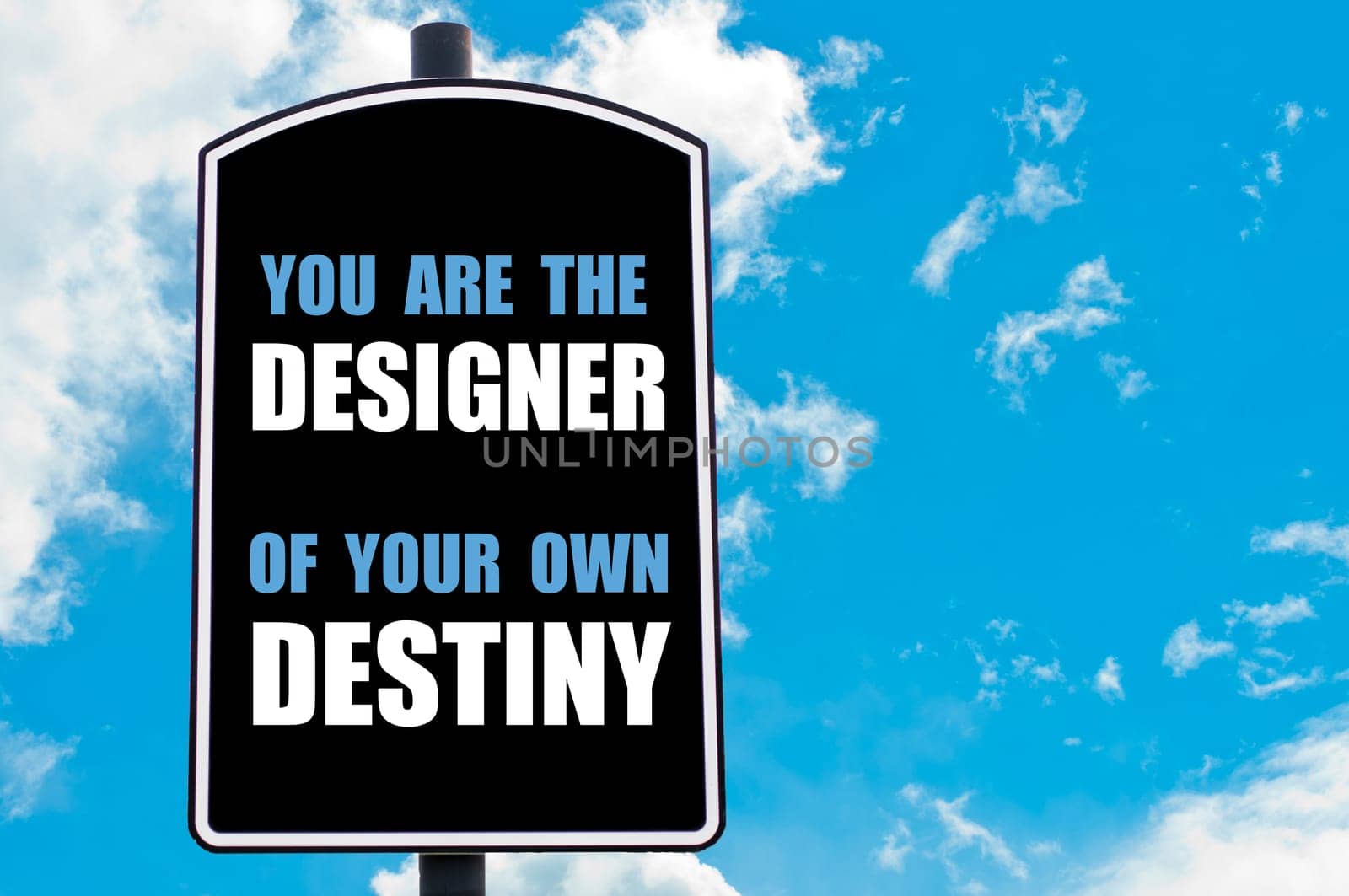 YOU ARE THE DESIGNER OF YOUR OWN DESTINY motivational quote written on road sign isolated over clear blue sky background with available copy space. Concept  image