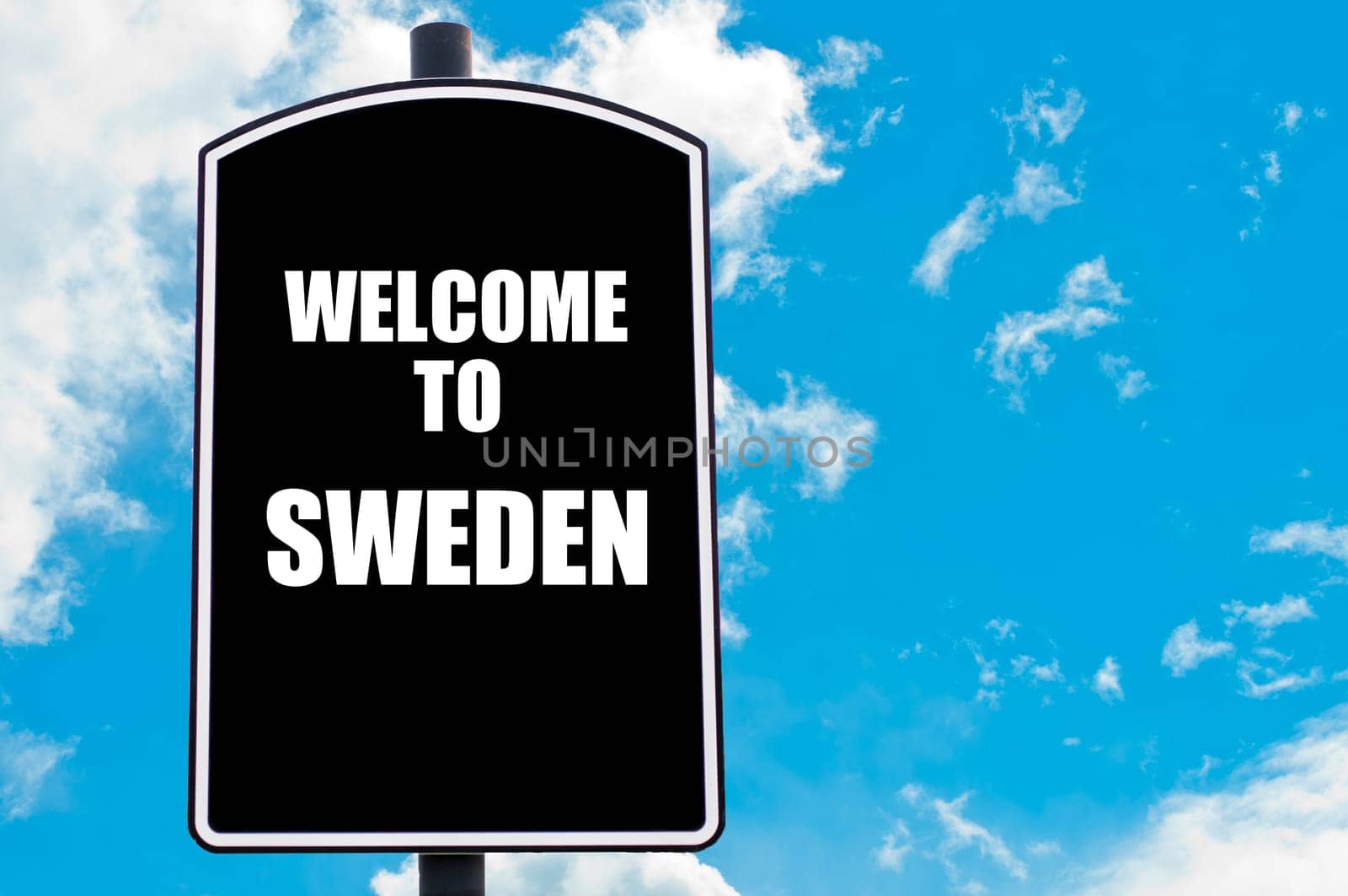 Black road sign with greeting message WELCOME TO SWEDEN isolated over clear blue sky background with available copy space. Travel destination concept  image