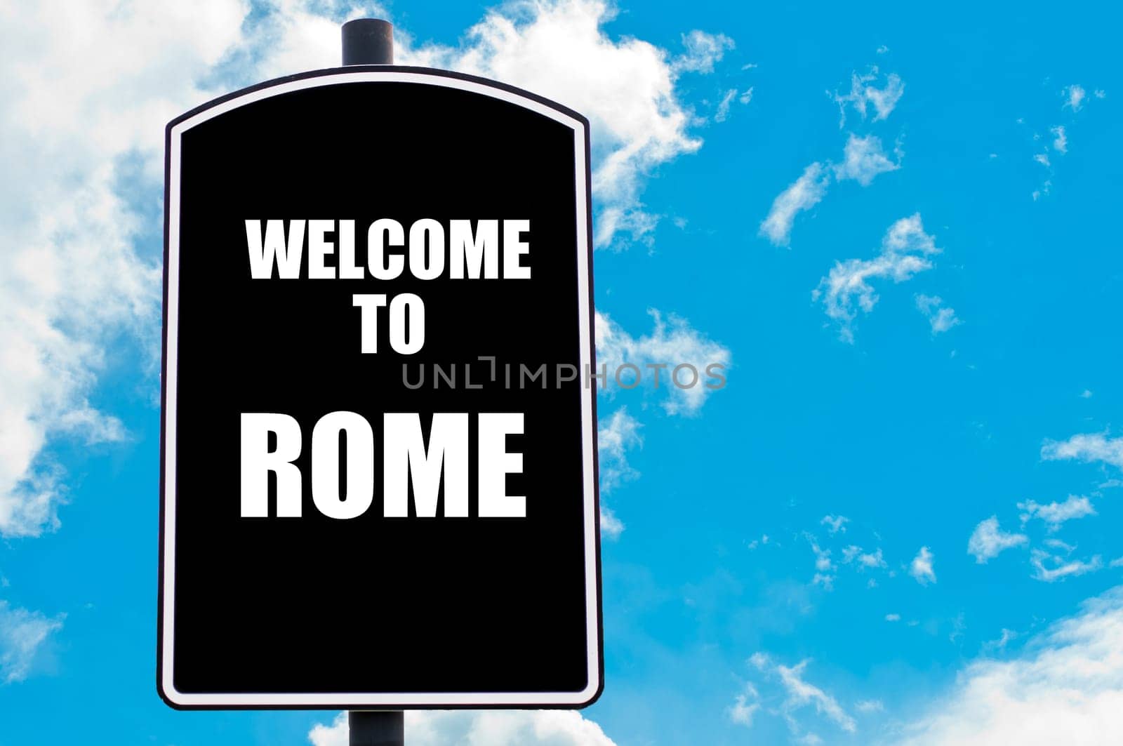 Black road sign with greeting message WELCOME TO ROME isolated over clear blue sky background with available copy space. Travel destination concept  image