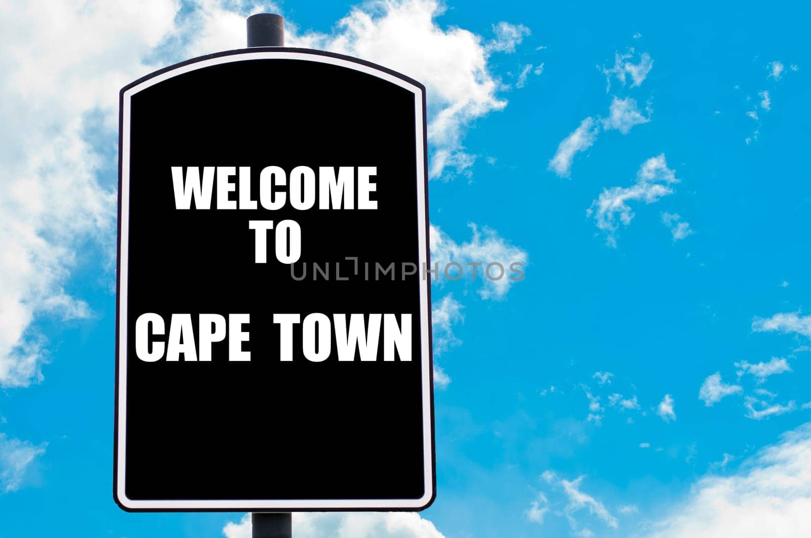 Black road sign with greeting message WELCOME TO CAPE TOWN isolated over clear blue sky background with available copy space. Travel destination concept  image
