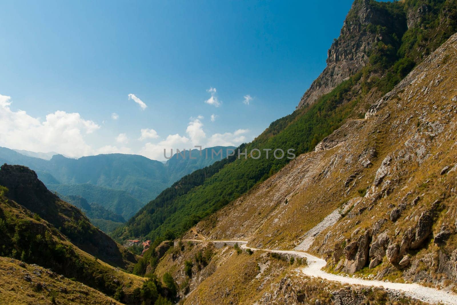 Ancient road in the valley below a cliff