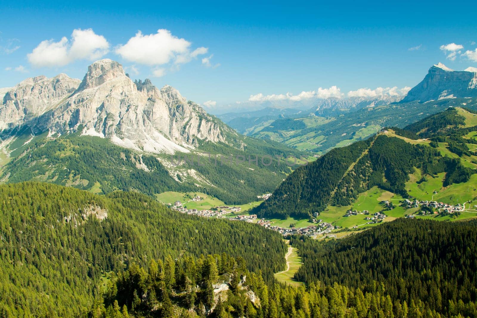 Green valley with the village of Corvara in the dolomities