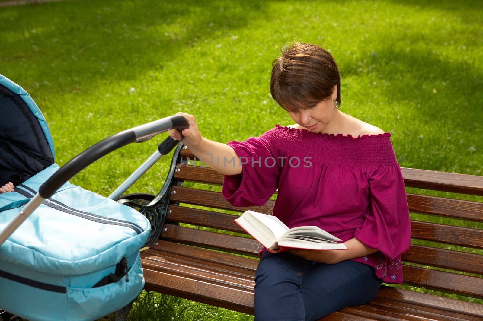 Mother and the newborn on walk in park