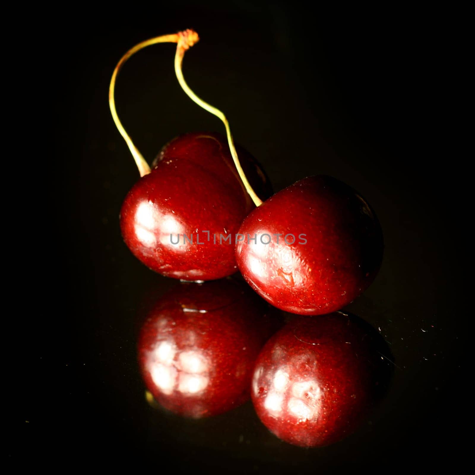 red pulpy cherry on black