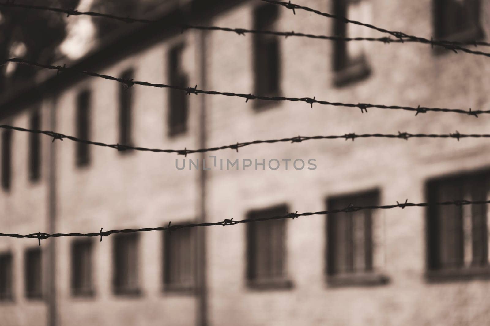 Barracks for prisoners behind barbed wire fence in Auschwitz Nazi concentration camp Poland