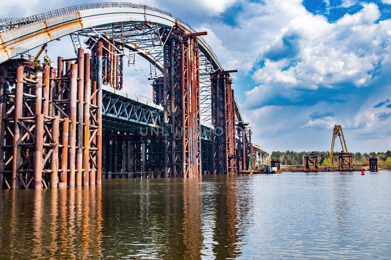 Reinforced concrete structure of the bridge under construction. Bridge over the Dnieper River in Kiev. Engineering structure. Building construction. Water crossing. Industry. Ukraine.