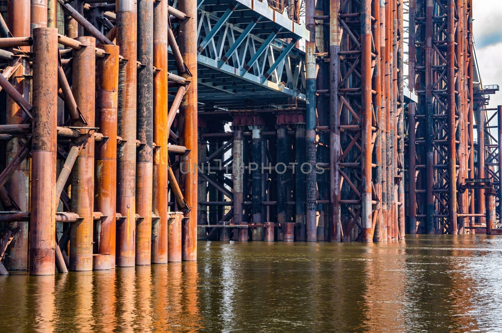 Reinforced concrete structure of the bridge under construction. Bridge over the Dnieper River in Kiev. Engineering structure. Building construction. Water crossing. Industry. Ukraine.