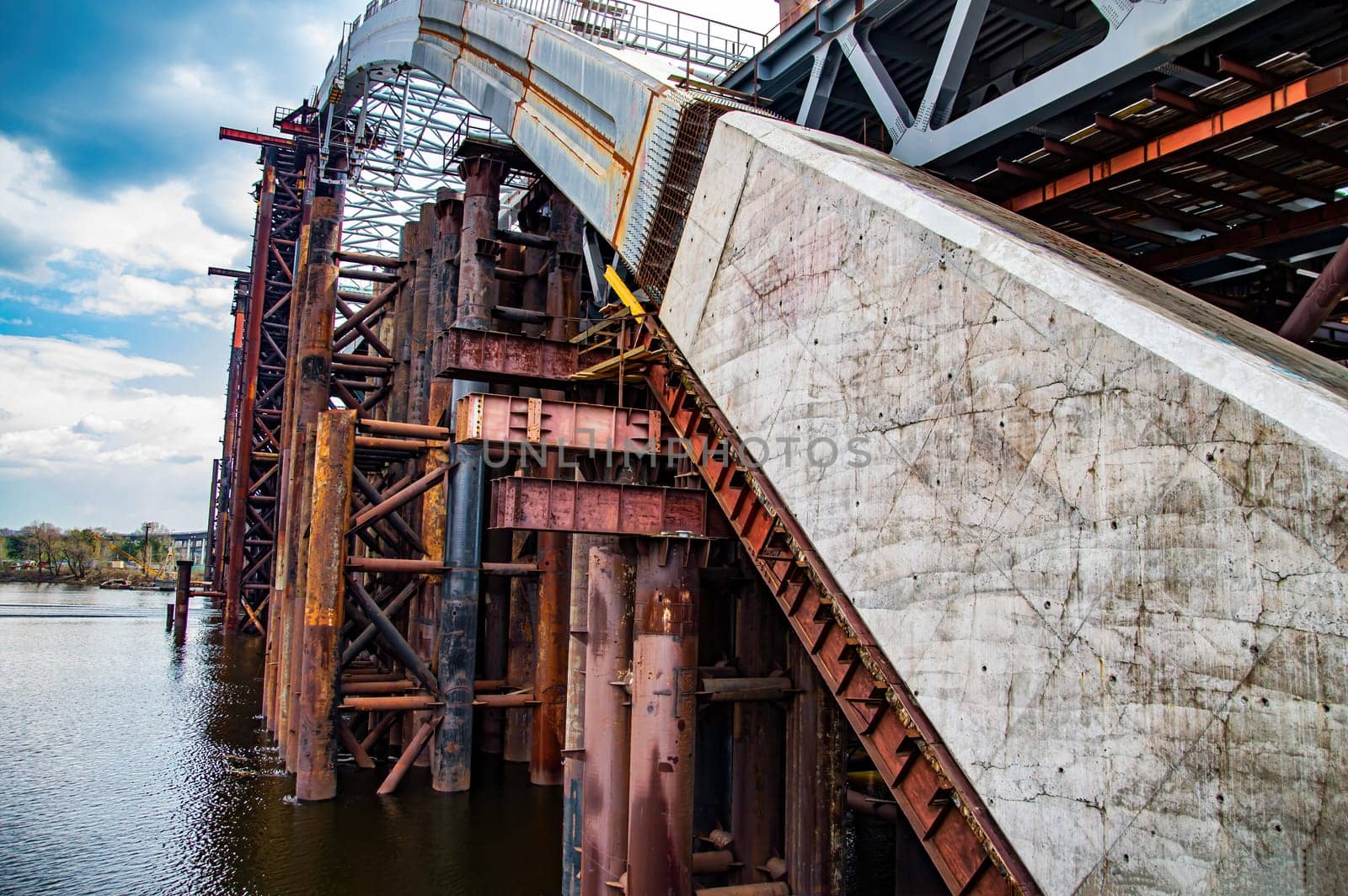 Reinforced concrete structure of the bridge under construction. Bridge over the Dnieper River in Kiev. Engineering structure. Building construction. Water crossing. Industry. Ukraine.