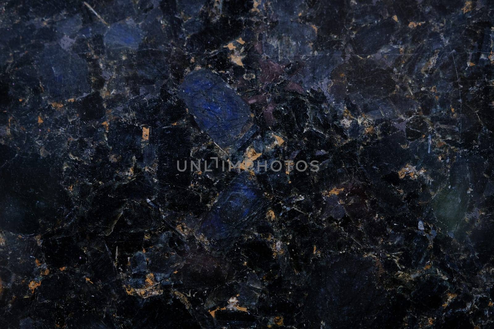 black marble texture with blue and yellow blotches abstract background pattern.