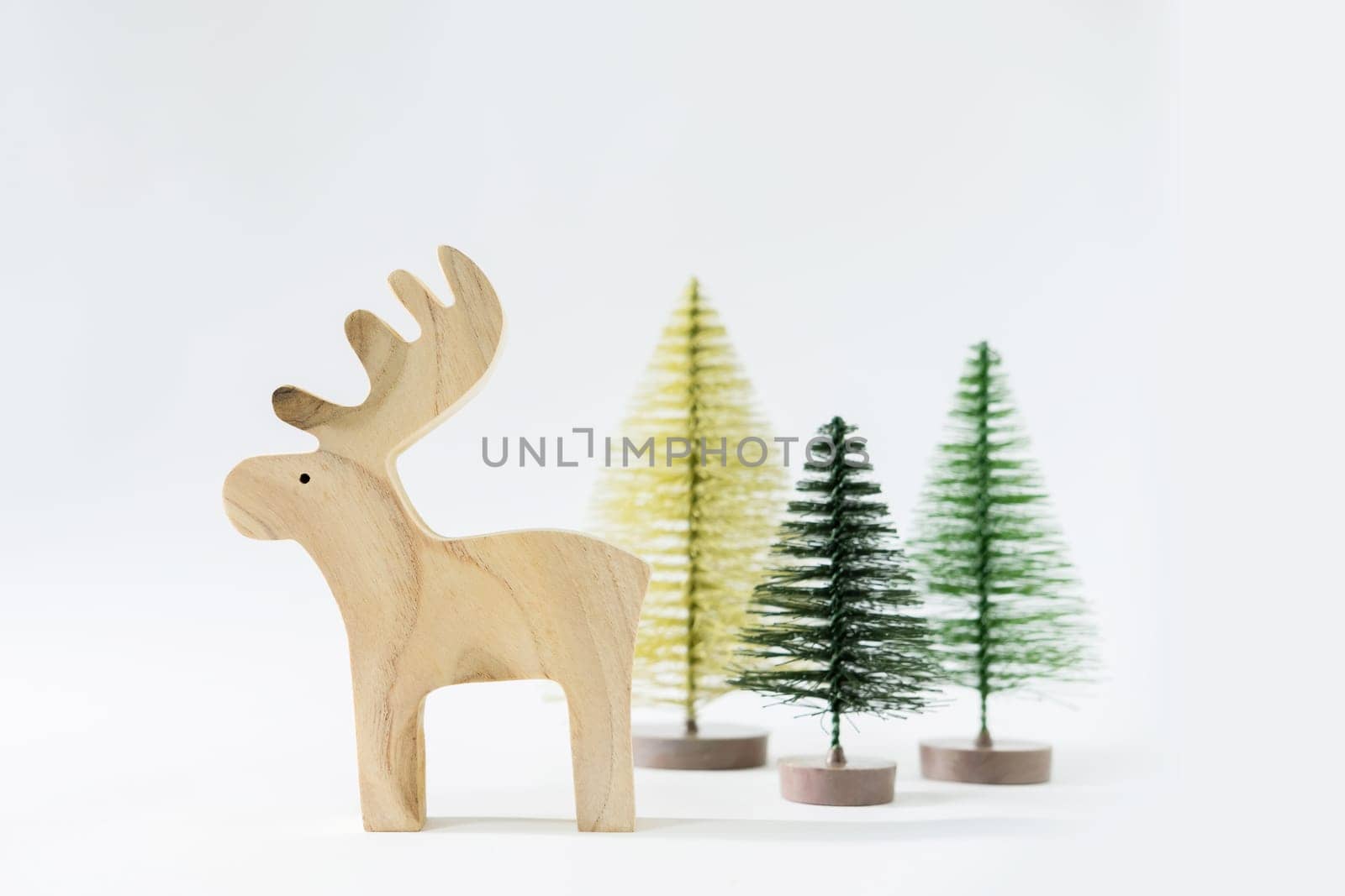 Christmas winter festive ornament. Reindeer and pine tree decoration on white background. Minimal holiday greeting season. Merry Christmas and Happy New Year.