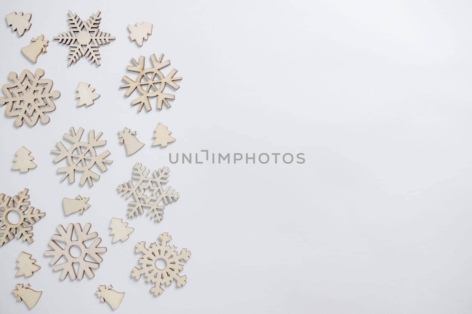 Christmas winter festive ornament. Christmas snowflakes decoration, pine trees and bells on white background. Christmas holiday decoration. Minimal holiday greeting season. Flat lay, top view.