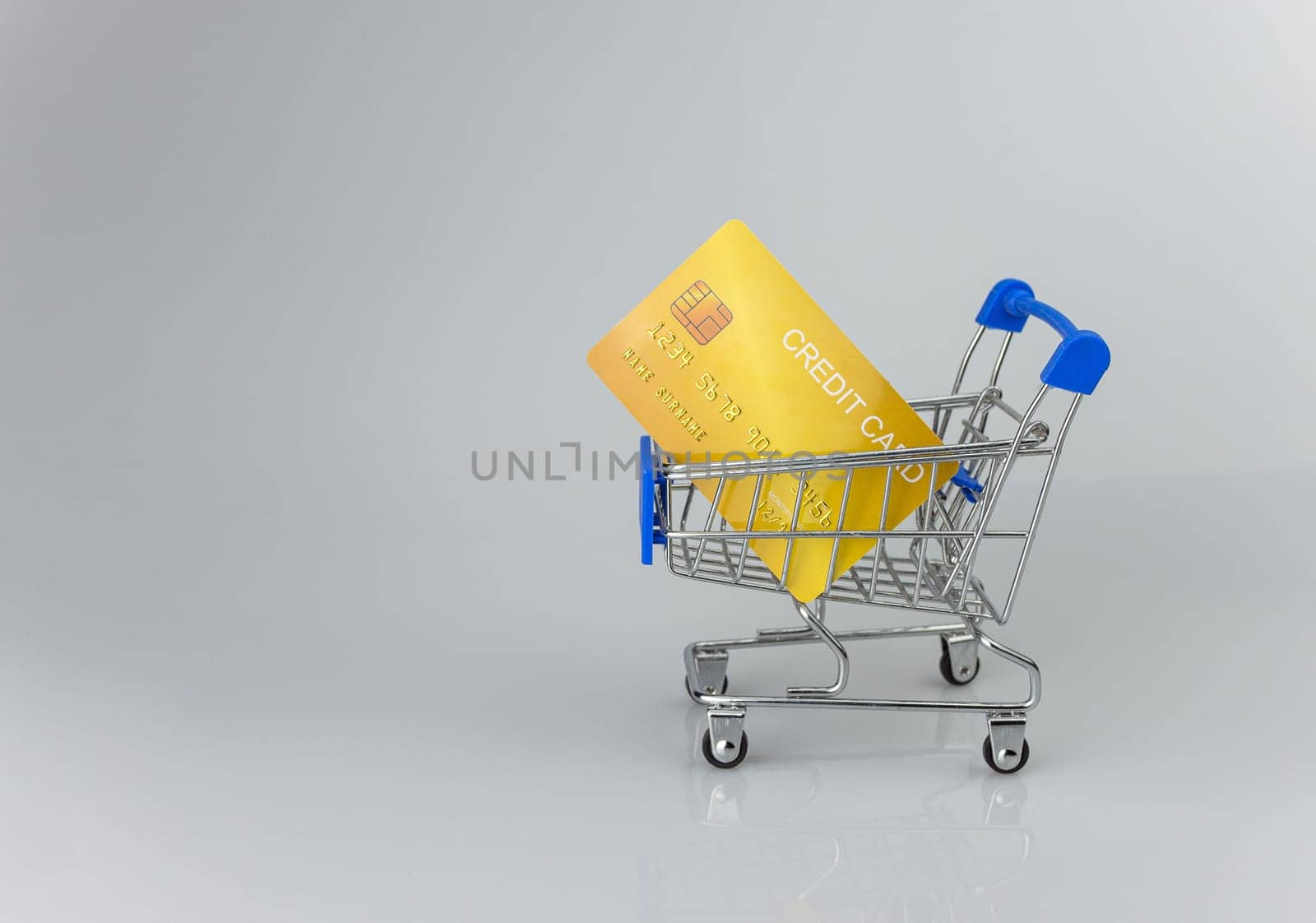 Shopping car and mockup credit card  on light and shadow background. shopping online concept.