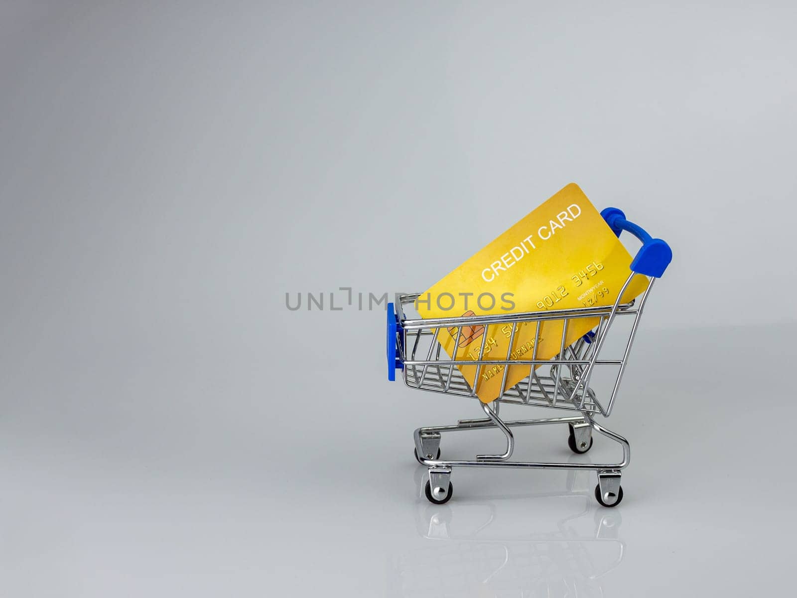 Shopping car and mockup credit card  on light and shadow background. shopping online concept.