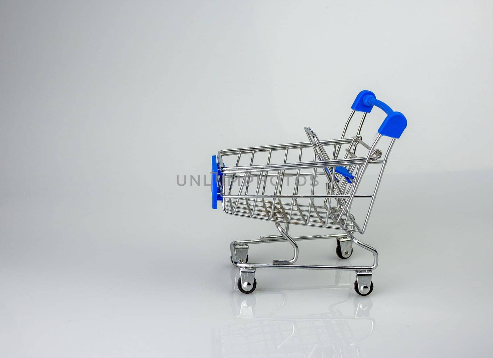 Shopping cart on white background with light and shadow. schopping concept.