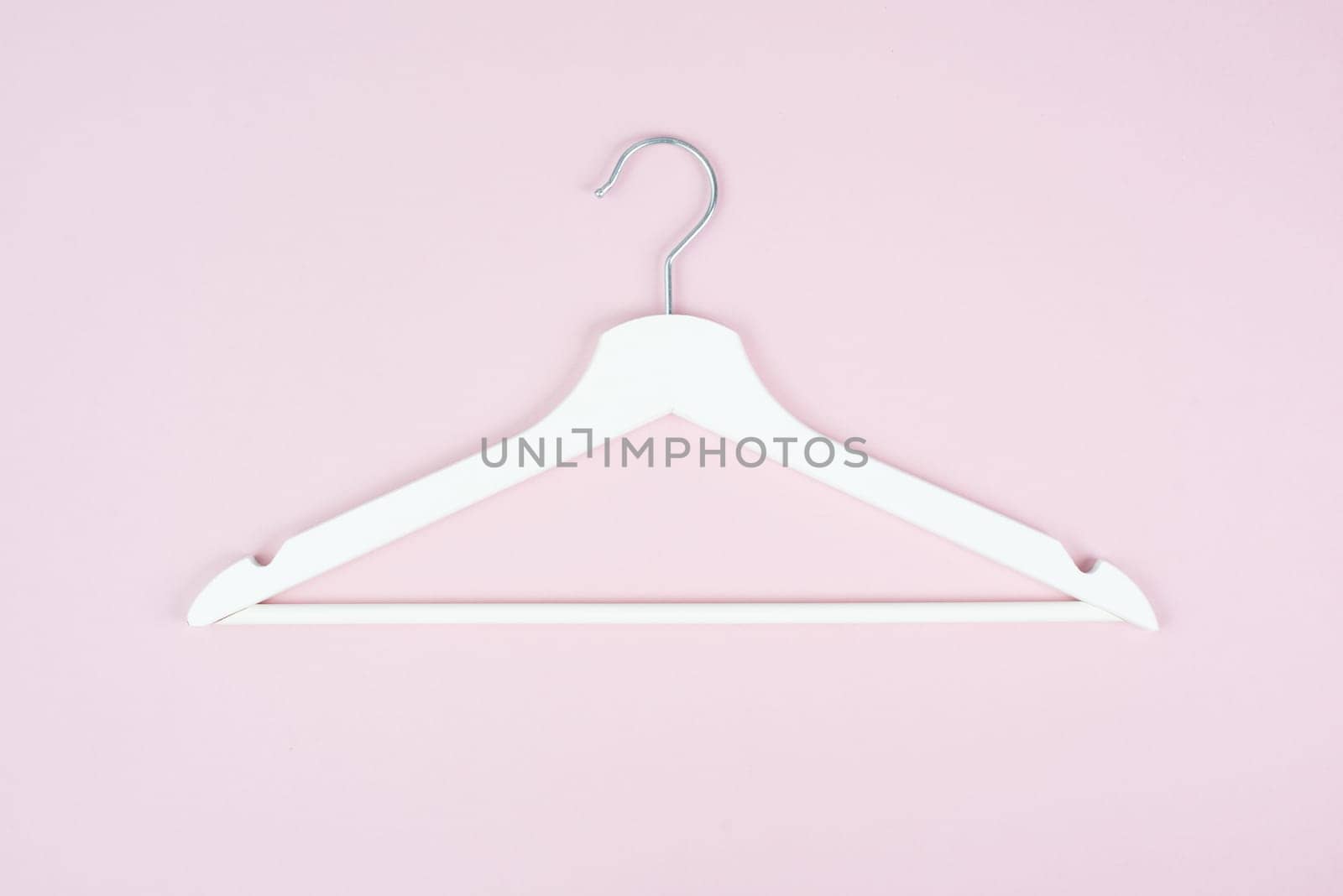 White hanger on a pastel background, fashion store, minimalism clothes, discount promotion