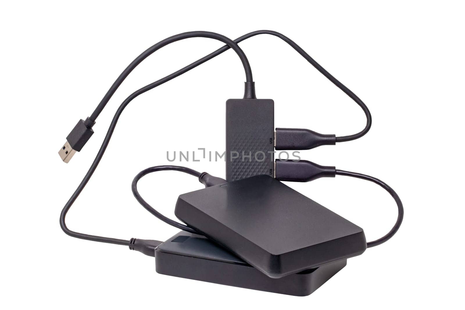 Two large capacity external hard drives connected via USB cable to a 4-port USB distributor isolated on white background. Clipping path. Connect to laptop for backing up files