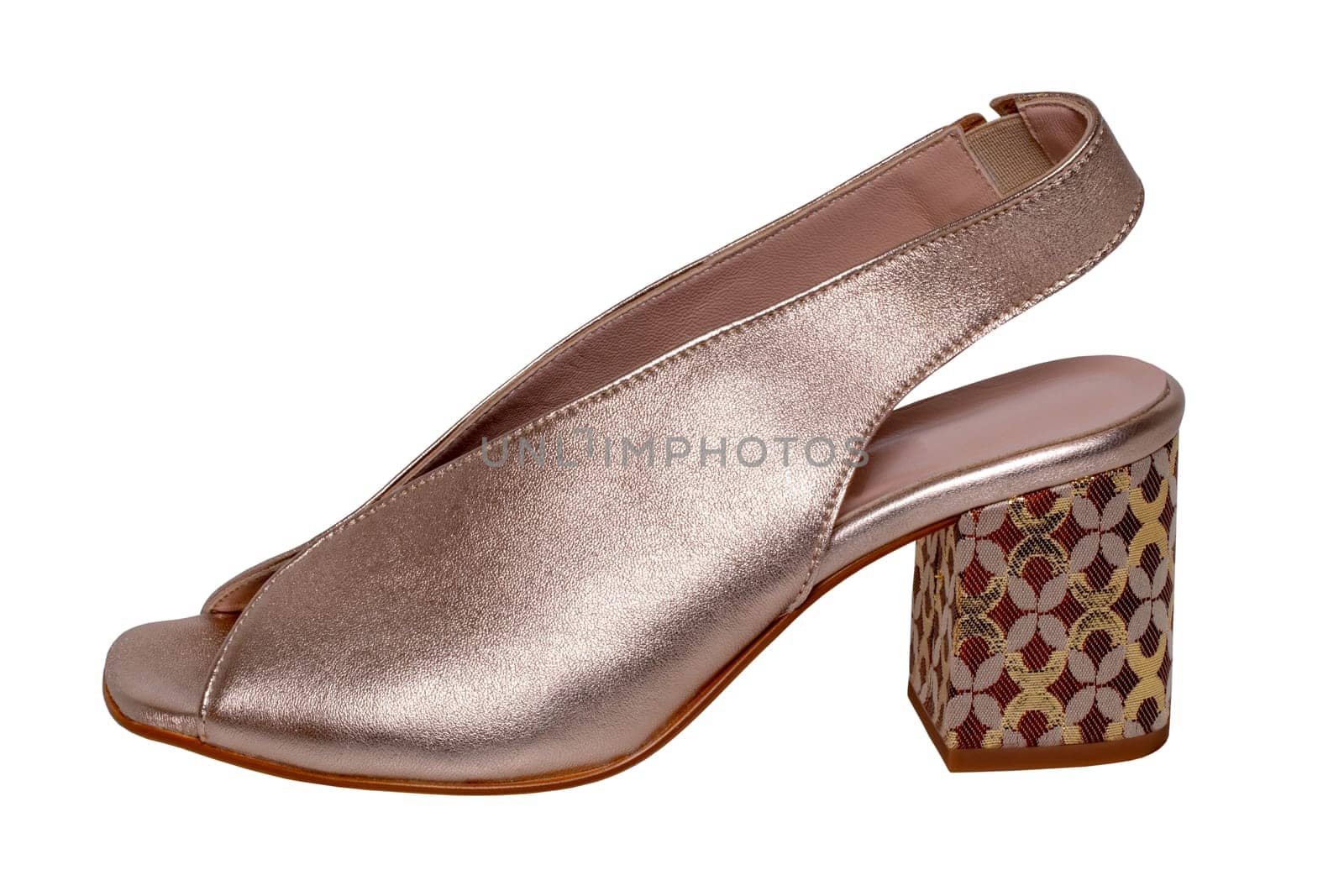 Golden shoes isolated. Close-up of a single elegant golden high-heeled shoe isolated on white background. Clipping path. Macro.